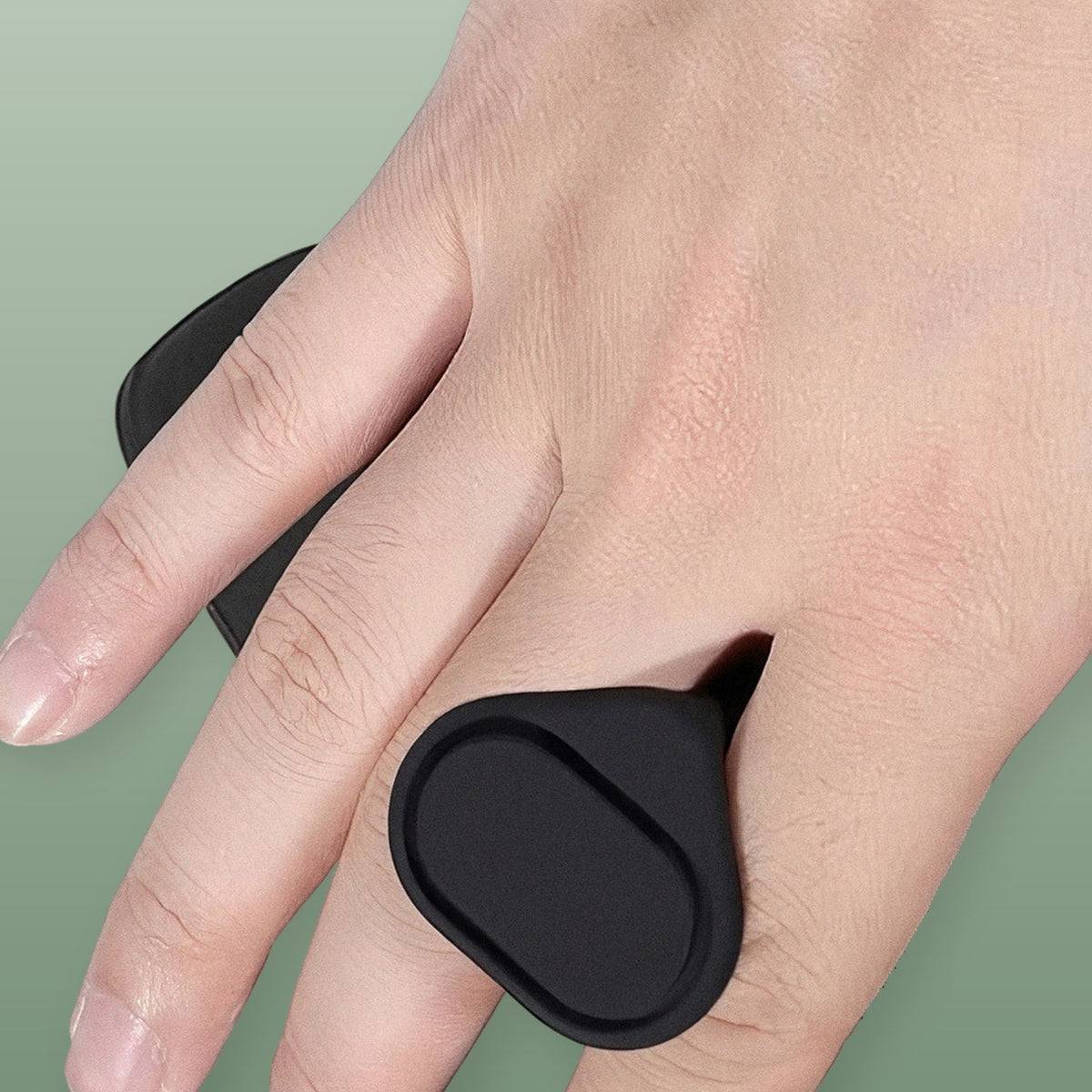 Real photo of the VOZA Kinetic Palm worn on the back of the hand, anchor pod secured between the fingers