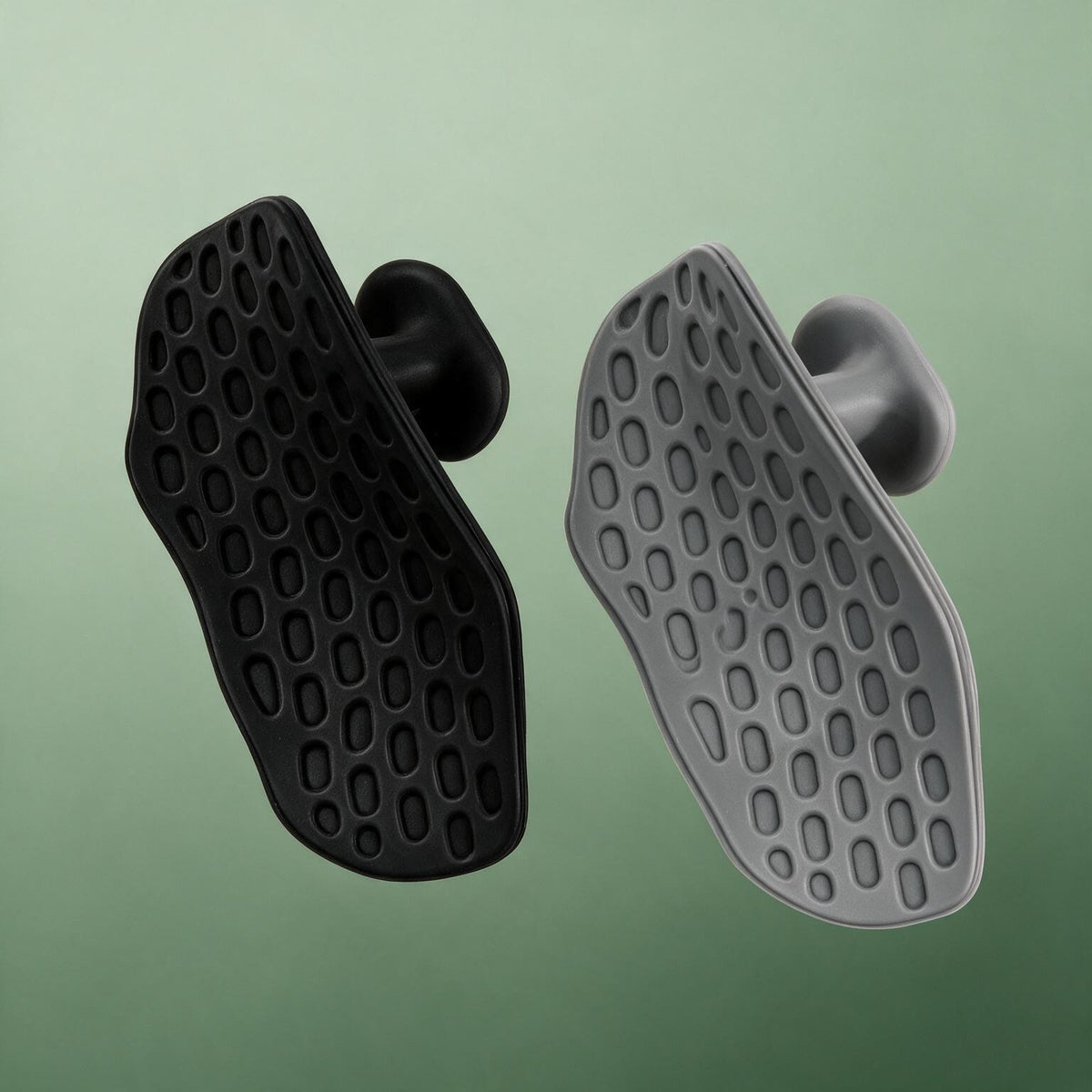 VOZA Kinetic Palm grip pads pair, black and graphite, honeycomb texture on sage backdrop